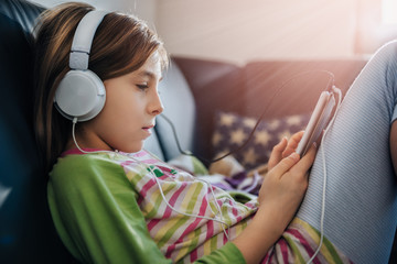 Girl using tablet and listening music