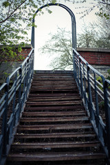 Iron stairs up in the park. Metal arch.