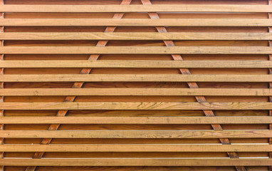 Wooden garden fence with stone paved pillars guarding private property.