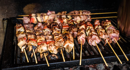 Grilling meat skewers  on natural charcoal barbecue grill.