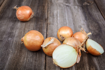 Fresh onions on a wooden background