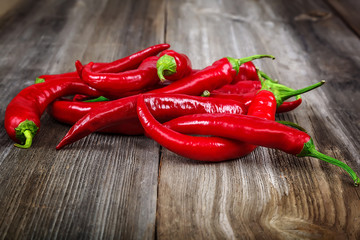 Red hot peppers on wooden background