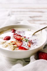 Strawberry Chia overnight oats served in a white bowl, selective focus