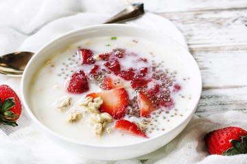 Strawberry Chia overnight oats served in a white bowl, selective focus