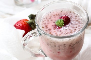 Strawberry Chia smoothie served in a glass mug, selective focus