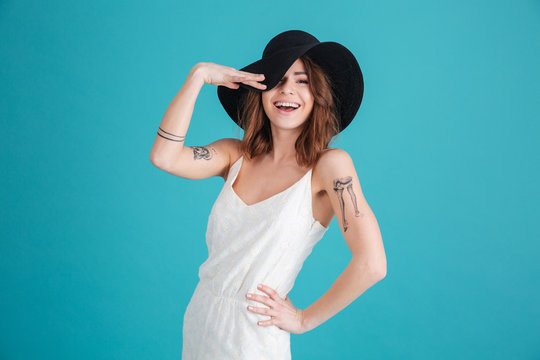 Portrait of a happy smiling girl wearing hat and posing