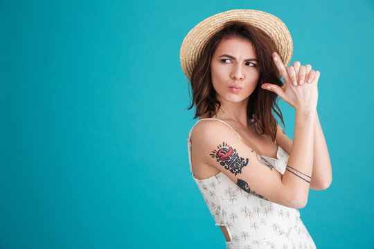 Portrait of a attractive girl in straw hat having fun