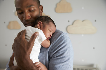 Father Holding Newborn Baby Son In Nursery - Powered by Adobe