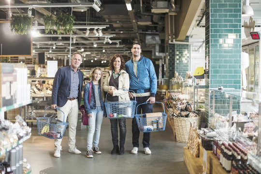 Portrait of family standing in organic food store