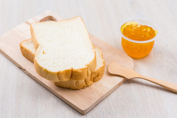 Breakfast with bread and jam on the wooden table