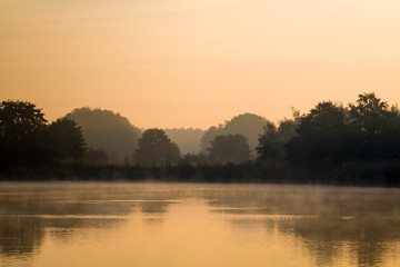 Fototapeta premium Morning fog above lake.