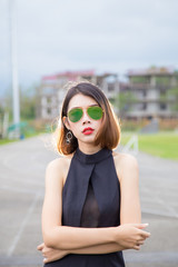 Fashion model Asian women Standing Poses and wear Black shirt. Short hair girl And wear sunglasses - 144862350