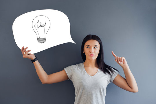 Woman holding a  speech bubble of white copy space with light idea bulb on it