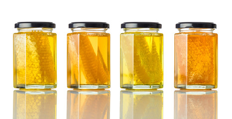 Different Types of Honey in Jar on White