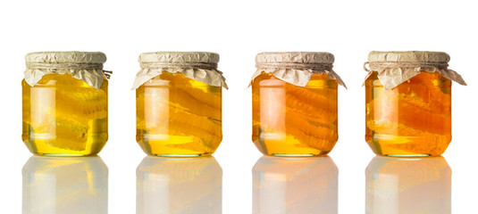Different Colors of Honey in Jar on White Background
