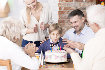 Boy blowing out candles