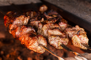 Appetizing meat grilled on skewers. Cooking shashlik