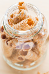 Crispy rolled wafer sticks, traditional dessert in Thailand, are collocated in a bottle.