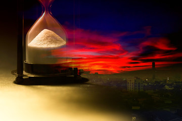 Hourglass on sunset of city (Concept of time)