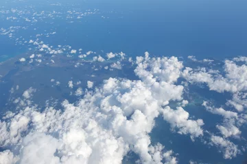 Aerial view on clouds and blue sky from airplane window © Glebstock