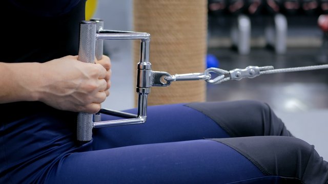 Close Up Shot. Athletic Young Woman Working Out On A Fitness Exercise Equipment At The Gym. Health, Sport And Workout Concept