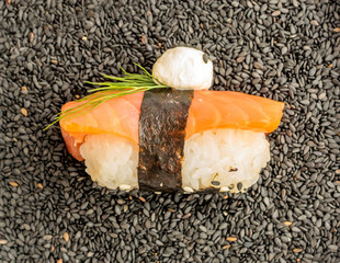 Nigiri Sushi with Salmon and Seaweed Nori on Dark Background
