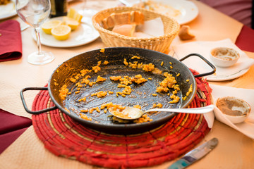 An empty pan for a spanish paella already finished at a restaurant somewhere in the spanish coast.