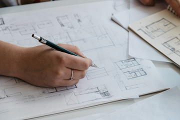 Young female architect working on sketches