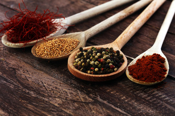 Various colorful spices on wooden table
