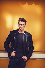 Smiling young man on yellow background