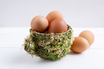 brown eggs in decorative cup, fresh eggs