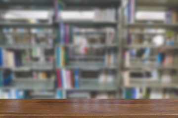 bookshelf in library with many books, blur background with selective focus wood table for display your product
