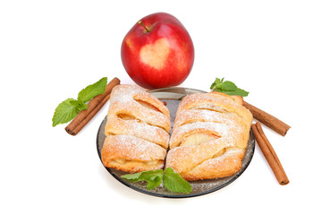  Buns with apple, cinnamon and mint sprinkled with powdered sugar on a plate, and red apple with heart