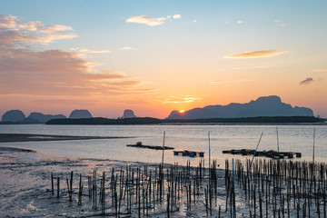 Landscape of riverside with mountains behind during the sunrise.