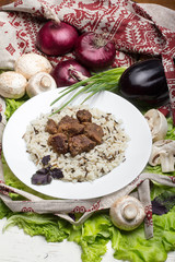 pork pieces with a garnish from brown rice