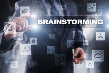 Businessman selecting brainstorming on virtual screen.