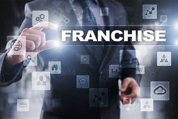 Businessman selecting franchise on virtual screen.