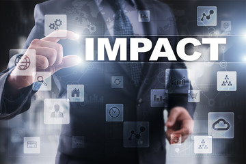 Businessman selecting impact on virtual screen.