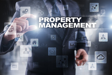 Fototapeta na wymiar Businessman selecting property management on virtual screen.