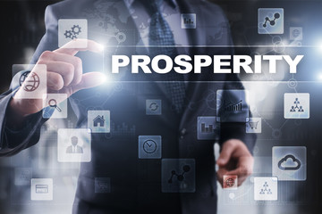 Businessman selecting prosperity on virtual screen.