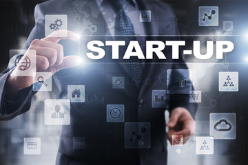 Businessman selecting start-up on virtual screen.