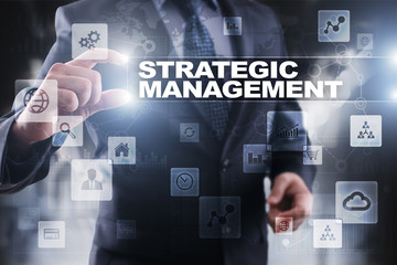Businessman selecting strategic management on virtual screen.