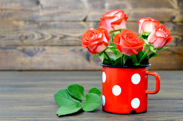 Mothers Day card with red roses in old cup