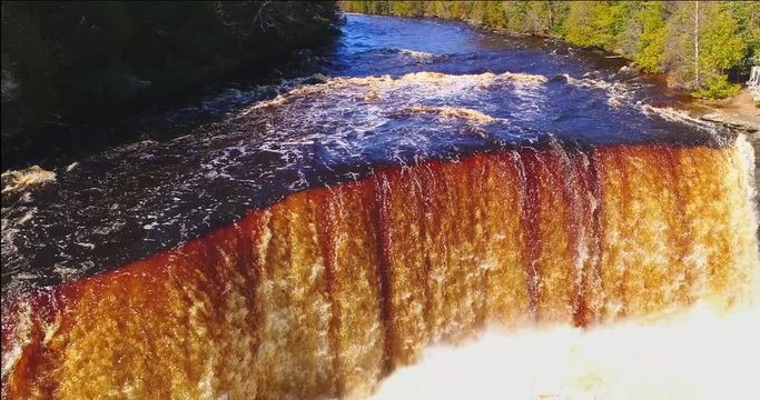 Springtime waterfall raging in Upper Michigan, this is upper Tahquamenon Falls, aerial view.