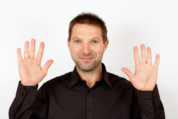 Portrait of a cheerful man showing palms