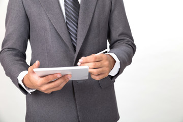 young asian startup entrepreneur businessman wearing gray suit using  digital tablet touchpad with touch pen over white background