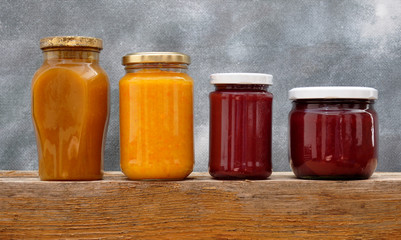 Jars with jam and nuts on the shelf