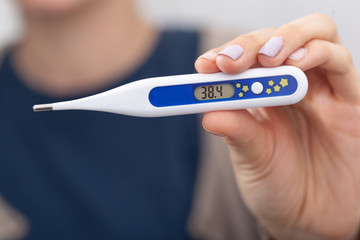 Sick women with a thermometer