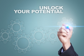 Businessman drawing on virtual screen. unlock your potential concept