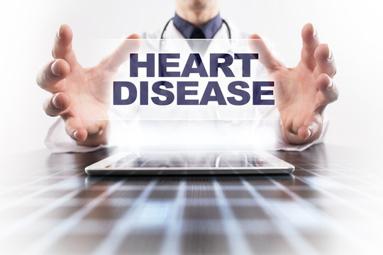 Medical doctor using tablet PC with heart disease medical concept.
